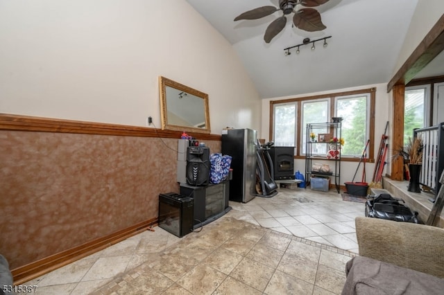 tiled living room with lofted ceiling, ceiling fan, and track lighting