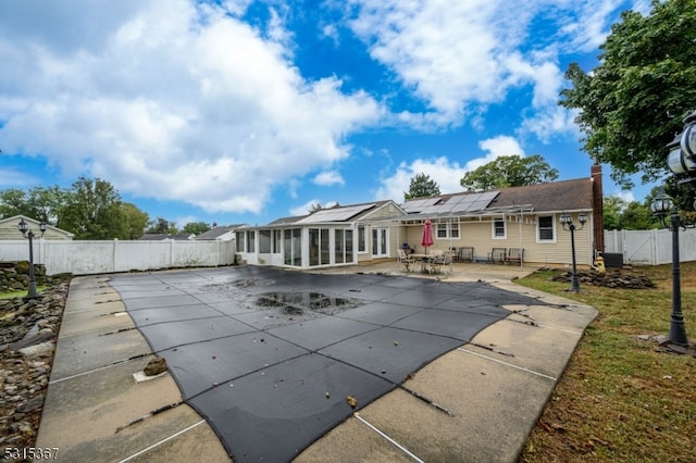 view of pool featuring a patio and a sunroom