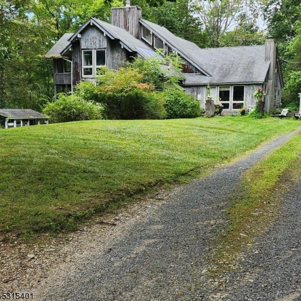 view of side of property with a yard