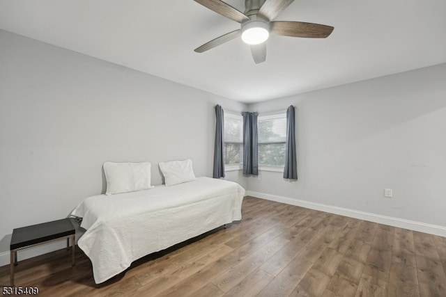 bedroom with ceiling fan and hardwood / wood-style floors