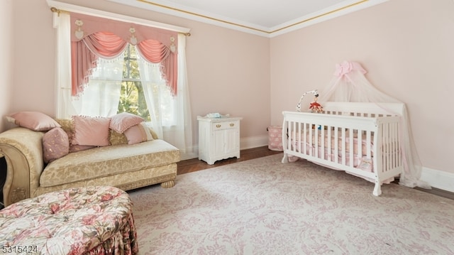 bedroom featuring hardwood / wood-style floors and crown molding