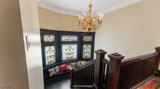 stairway featuring ornamental molding, a notable chandelier, and wood-type flooring