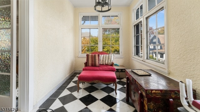 sunroom / solarium with a chandelier