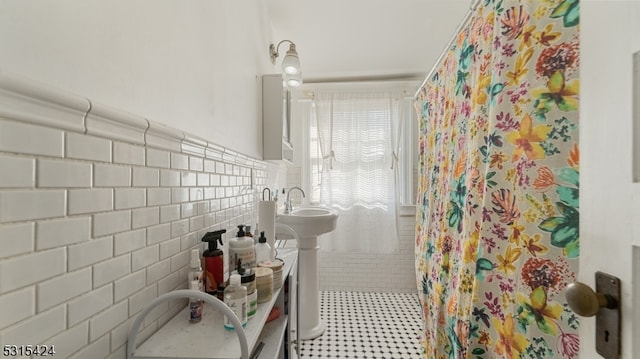 bathroom featuring tile walls and a shower with curtain