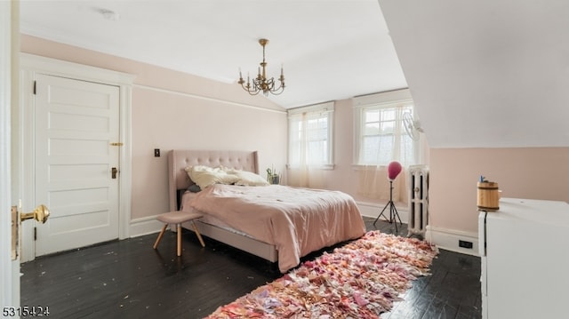 bedroom featuring lofted ceiling, dark wood-type flooring, and a chandelier