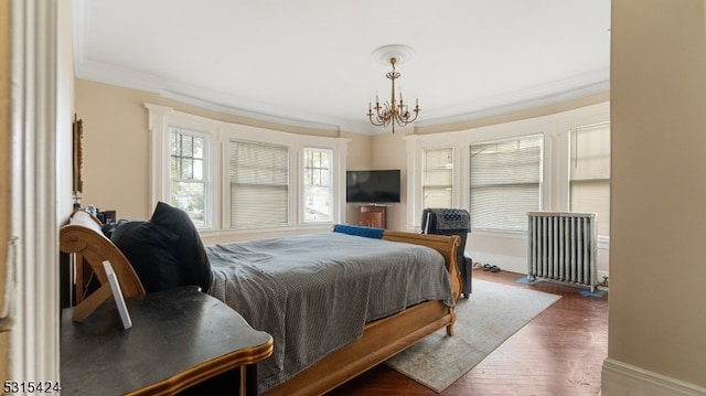 bedroom with crown molding, an inviting chandelier, and dark hardwood / wood-style flooring