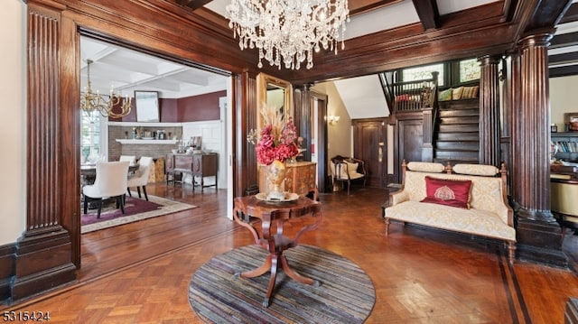 sitting room featuring parquet flooring, ornate columns, coffered ceiling, beamed ceiling, and a chandelier