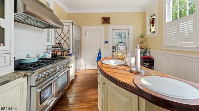 kitchen with range with two ovens, dark hardwood / wood-style flooring, plenty of natural light, and ventilation hood