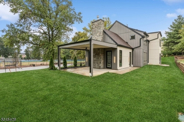 rear view of house with a patio area and a yard