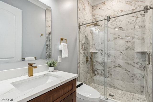 bathroom with a shower with door, vanity, and toilet