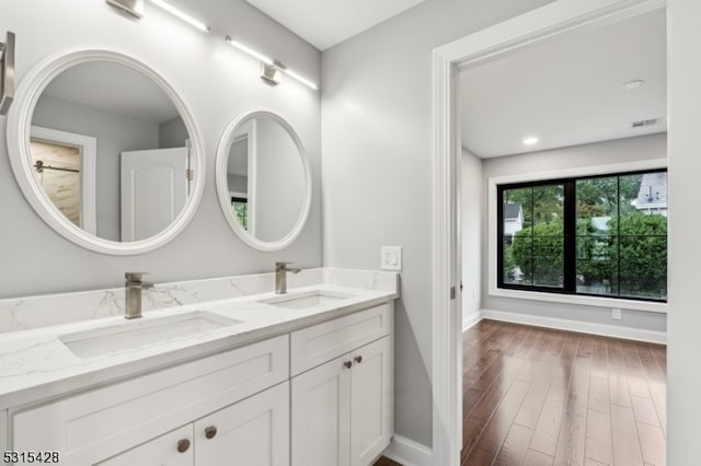 bathroom with vanity and hardwood / wood-style flooring