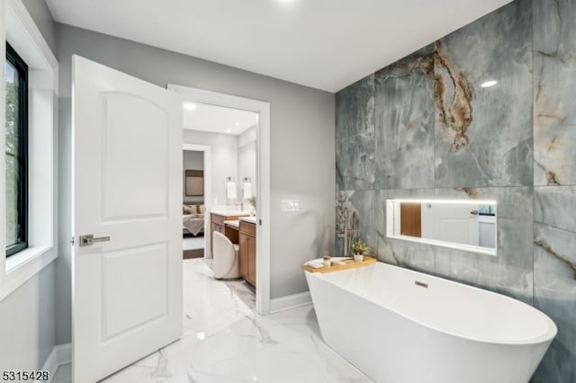 bathroom with a bathtub and tile walls