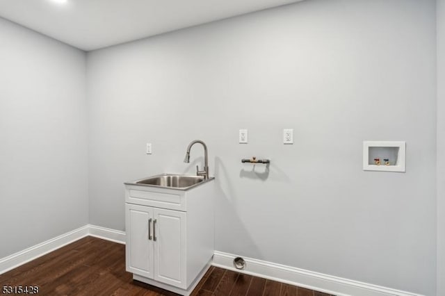 laundry area with a sink, baseboards, hookup for a washing machine, and dark wood-style flooring