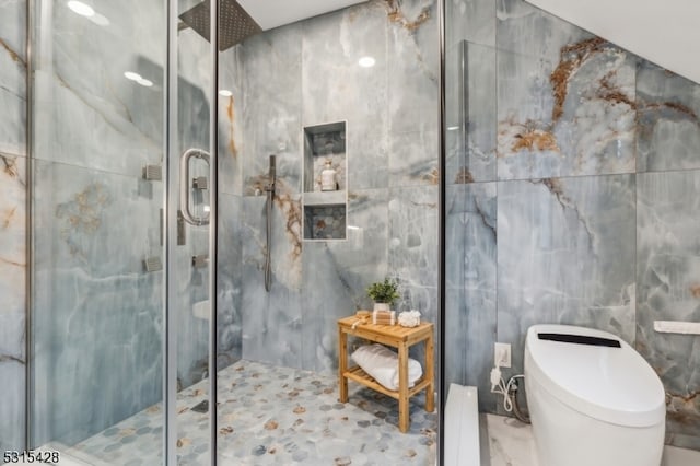 bathroom featuring walk in shower, tile walls, baseboard heating, and toilet