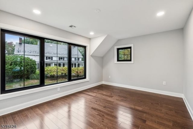 bonus room featuring visible vents, baseboards, recessed lighting, and dark wood-style floors