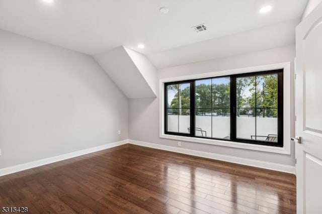 additional living space featuring recessed lighting, baseboards, vaulted ceiling, and wood finished floors