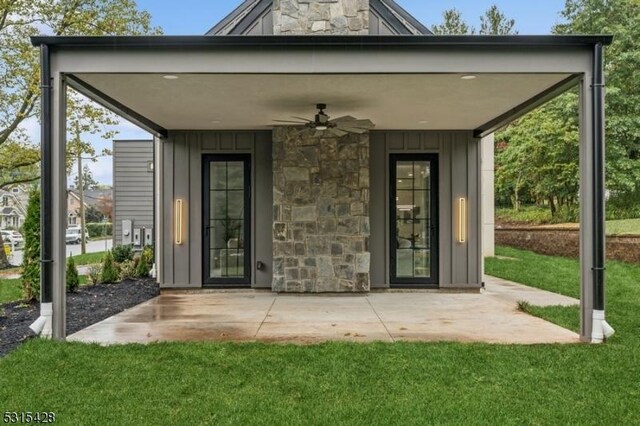 exterior space with board and batten siding, ceiling fan, and stone siding