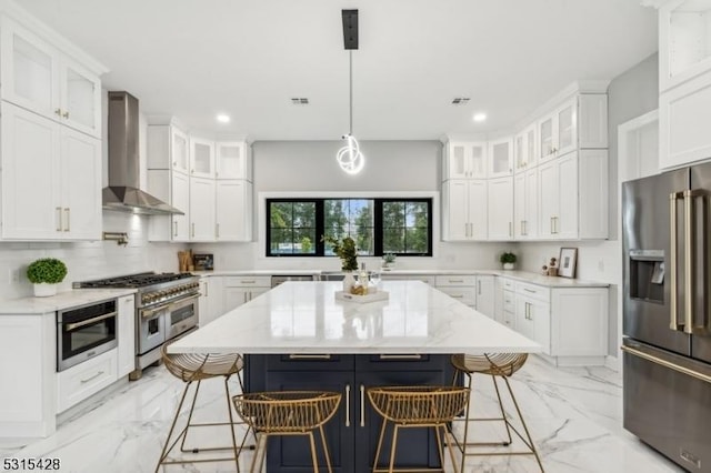 kitchen with wall chimney range hood, high quality appliances, a kitchen breakfast bar, and marble finish floor