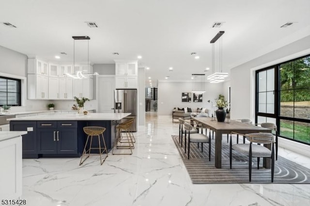 kitchen with stainless steel fridge with ice dispenser, visible vents, white cabinetry, and marble finish floor