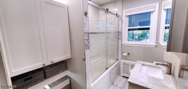 bathroom featuring bath / shower combo with glass door and vanity