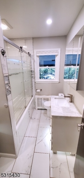 full bathroom with toilet, bath / shower combo with glass door, and vanity