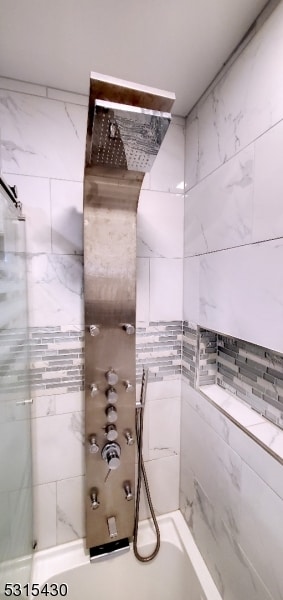 bathroom featuring tiled shower / bath