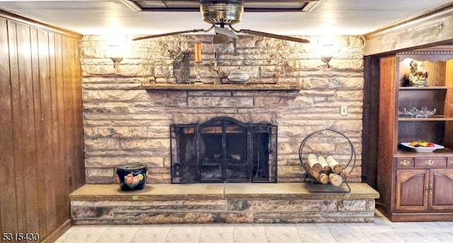 details featuring a fireplace, crown molding, and ceiling fan