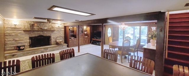 dining room with a stone fireplace