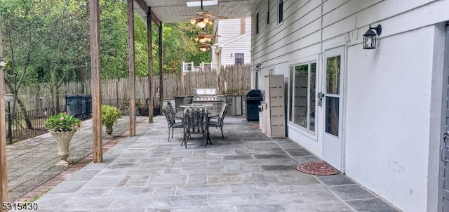 view of patio with ceiling fan and area for grilling