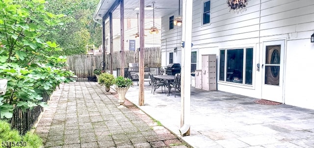 view of patio featuring ceiling fan and a grill