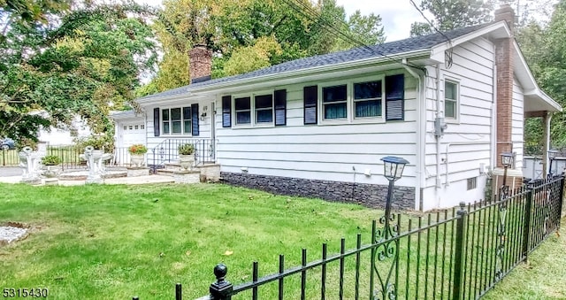 view of front of home featuring a garage and a front yard