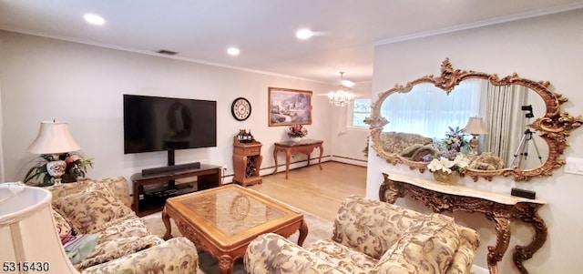 living room with ornamental molding, a notable chandelier, wood-type flooring, and baseboard heating