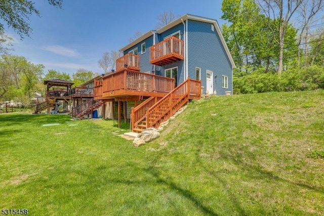 back of house with a wooden deck and a yard