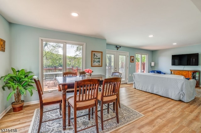 dining area with light hardwood / wood-style floors, french doors, and plenty of natural light