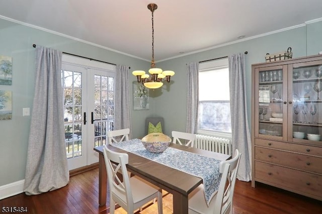 dining area featuring a notable chandelier, french doors, radiator heating unit, dark wood finished floors, and crown molding