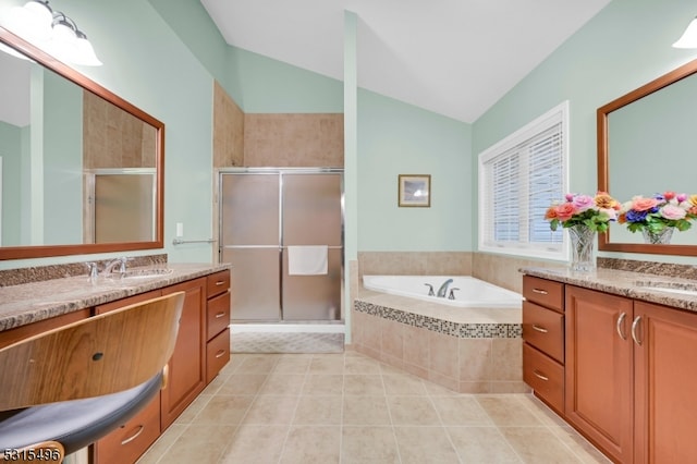 bathroom featuring vanity, vaulted ceiling, and separate shower and tub