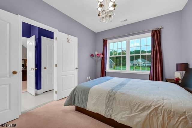 carpeted bedroom featuring a chandelier