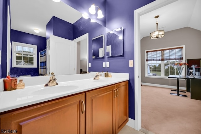 bathroom with vanity and vaulted ceiling