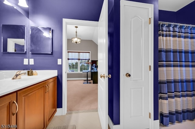 bathroom featuring vanity, vaulted ceiling, curtained shower, and tile patterned flooring