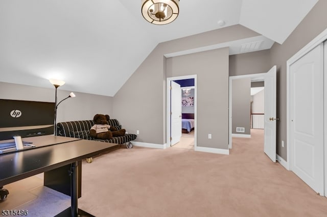 carpeted office space featuring lofted ceiling