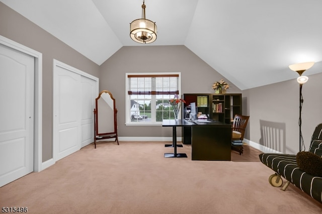 office with lofted ceiling and carpet floors