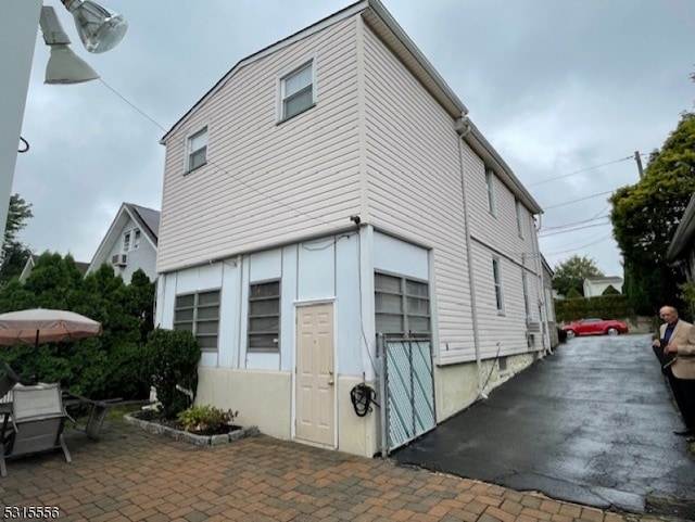 view of property exterior with a patio