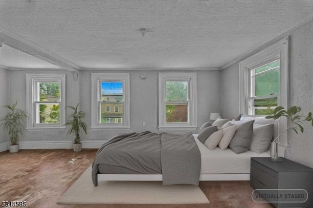 bedroom featuring a textured ceiling and multiple windows