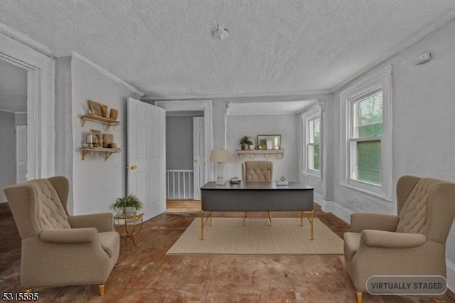 living room with a textured ceiling, ornamental molding, and hardwood / wood-style flooring