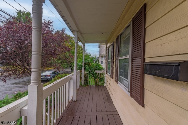 wooden terrace with a porch