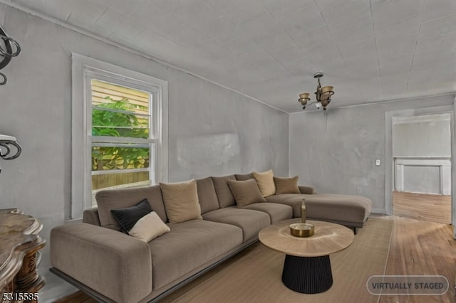 living room featuring wood-type flooring and a chandelier