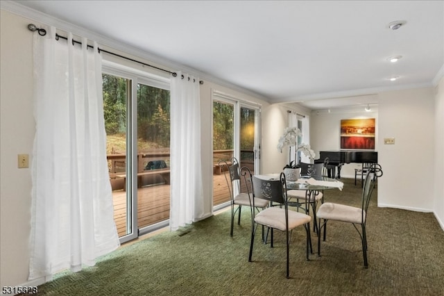 dining room featuring carpet flooring and crown molding