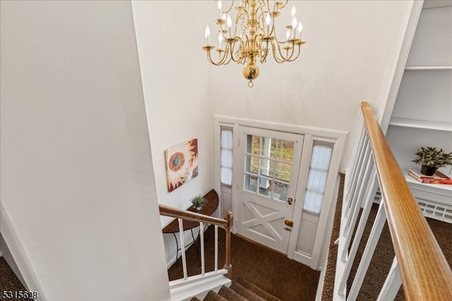 carpeted entryway with an inviting chandelier