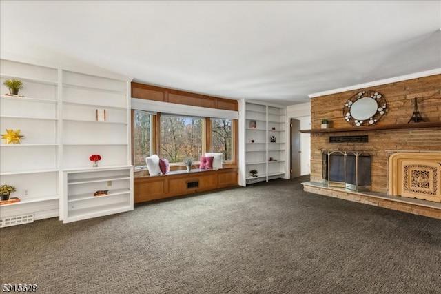 unfurnished living room with dark carpet and a fireplace