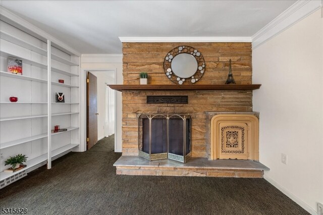 unfurnished living room featuring dark colored carpet, a stone fireplace, and crown molding